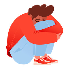 Very upset young man sits in protective position, clasping both hands around his knees and resting his head on them, his face contorted in grief. Concept of sadness, grief, psychological health