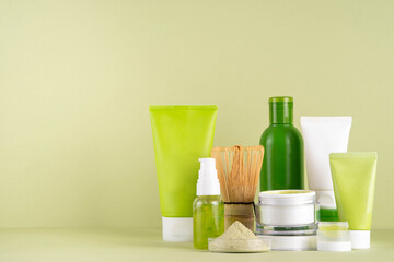 Matcha Skincare Cosmetics Background containing matcha powder, cream, serum, face mask, scrub, toner and moisturizer, natural clean beauty anti-aging skin care beauty trend