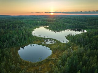 Fototapeta premium Aerial view of forest and lakes at sunset.