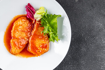 Fish tomato sauce whitefish fillet appetizer dish organic fresh tasty gourmet food background on the table rustic food top view copy space keto paleo diet vegetarian food pescetarian diet