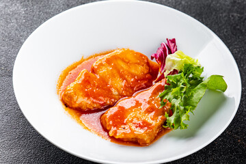 Fish tomato sauce whitefish fillet appetizer dish organic fresh tasty gourmet food background on the table rustic food top view copy space keto paleo diet vegetarian food pescetarian diet