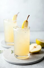Fototapeta premium Refreshing pear soda water mocktail cocktail in glass, gray concrete background. Non alcoholic summer drink with pear slices, ice. Vertical orientation, copy space. Perfect for cafe, restaurant, bar
