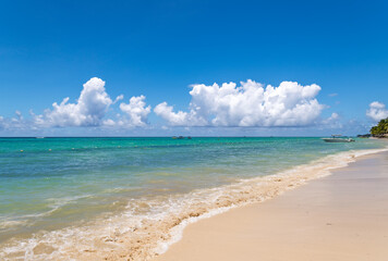 Pristine Caribbean Beach with Turquoise Water and Fluffy White Clouds.Perfect Summer Beach Scene with Calm Turquoise Ocean and White Clouds