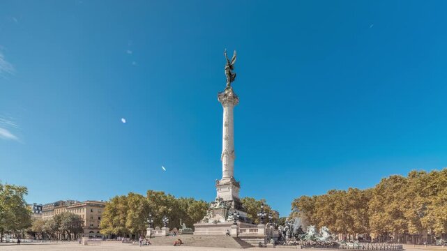 Monument Aux Girondins with fountain on Esplanade Des Quinconces timelapse hyperlapse in Bordeaux, France. Historic landmark and architectural masterpiece symbolizing liberty and revolution. Blue sky