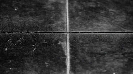 Fototapeta premium Close-up of an old black marble floor's top right corner with a single white dust line between two cross lines, monochrome and cinematic, perfect for texture and background use.
