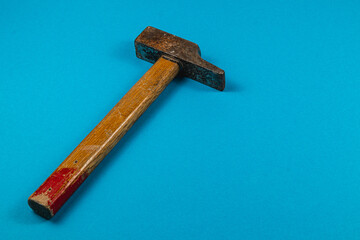 Tool resting on blue surface in a workshop setting