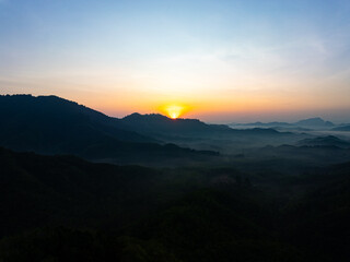 Beautiful sunset or sunrise sky nature landscape in Thailand,Amazing landscape colorful clouds over mountains in summer season background,Wide angle view drone shot