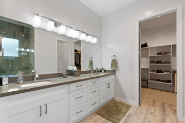 Spacious bathroom with two sinks and a convenient walkin closet