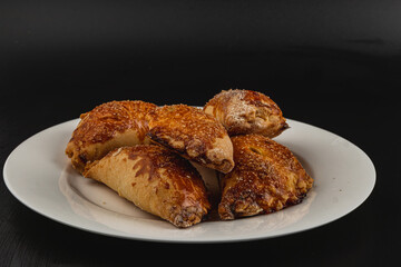 Pumpkin pastries arranged on a white plate against a dark background