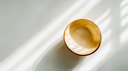 Photo of a round serving bowl on a white background, in natural light, with low contrast