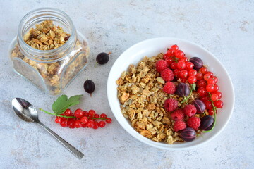 Healthy breakfast bowl with granola and fresh berries flat lay