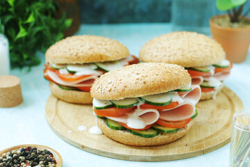 Bun sandwiches with salami and vegetables