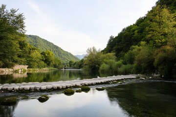 Stepping stones cross the river in lush mountain valley scene