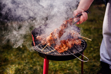 Grilling Meat Skewers Over Hot Charcoal at Outdoor BBQ