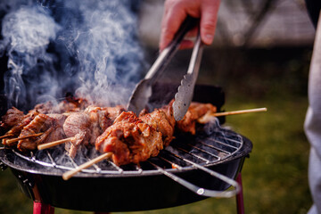 Grilling Meat Skewers Over Hot Charcoal at Outdoor BBQ