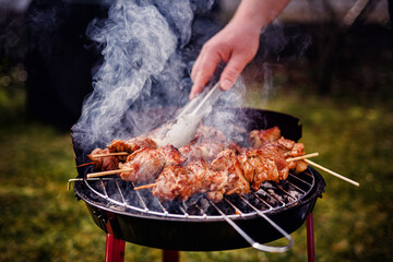 Fototapeta premium Grilling Meat Skewers Over Hot Charcoal at Outdoor BBQ