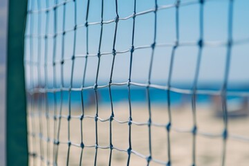 Volleyball net, beach, ocean, blue sky in the blurred background