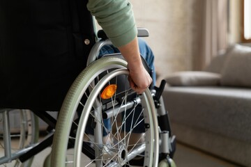 A disabled person moving a wheelchair at home, showing self-reliance and accessibility in a domestic setting.
