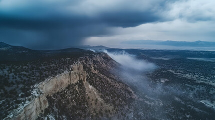 Dramatic landscape with stormy skies and rocky cliffs shrouded in mist.  A powerful depiction of nature's raw beauty. Serene yet powerful scenery with imposing natural landscape.