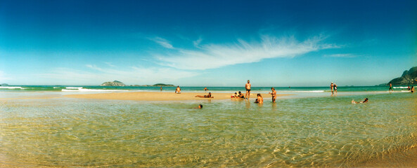 People swimming and enjoying in the ocean, Ipanema beach, Rio de Janeiro, Brazil.