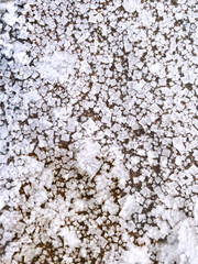 top view of crystallized salt formations near sea coast