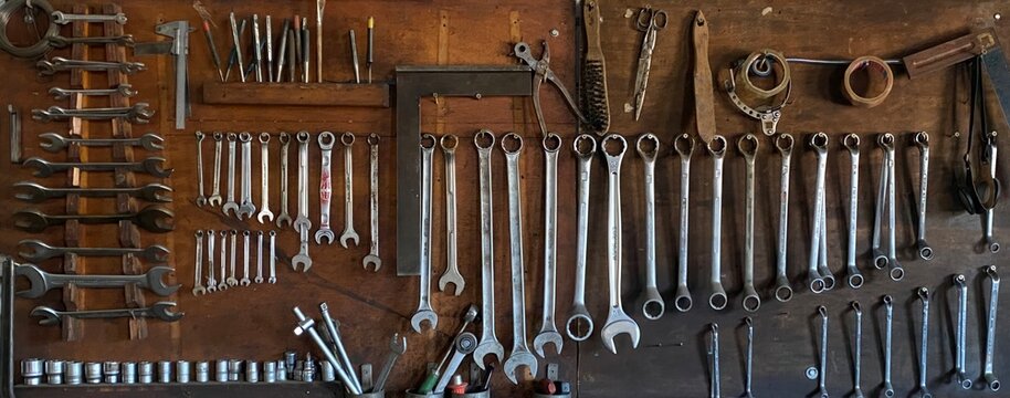 wooden tool board with structured mechanic tools in workshop