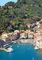 Fototapeta premium Portofino, Italy - 07 April 2025. Yachts, boats in bay of Liguria. Sea and tourism in Italy. Traditional buildings. Background for design.
