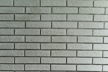 textured background of a white brick wall.