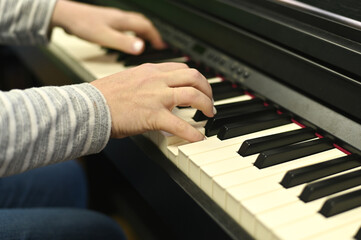 Fototapeta premium Woman playing modern digital piano, focusing on melody creation and performance