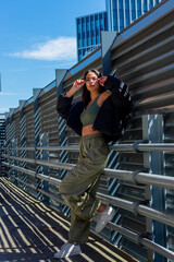 Cool attitude Gen Z woman posing in an urban setting in a parking garage