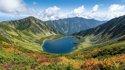 Fototapeta premium A breathtaking mountain landscape featuring a serene lake surrounded by colorful foliage and dramatic peaks under a bright blue sky.
