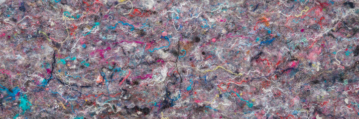 Colorful thermobond felt background of orthopedic mattress layer. Closeup. Wide banner. Top down view.