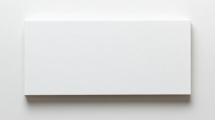 Fototapeta premium Blank white canvas on a white surface, ideal for painting or mockup purpose