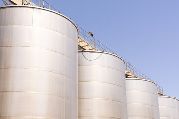 Metal tanks used for winemaking in a Sicilian winery on a clear day
