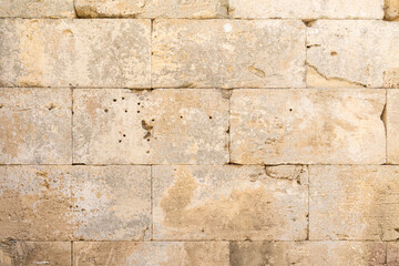 Old beige limestone wall forming a textured background