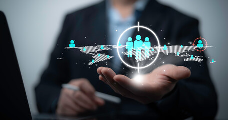 Businessman using digital interface for global customer targeting and audience segmentation strategy with futuristic network data visualization