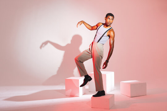 African American man posing confidently in stylish outfit in modern studio
