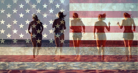 Digital composite of girls running into the ocean at beach against american flag background