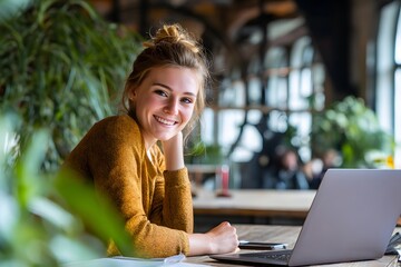 a beautiful woman sitting and using laptop with her face filled with confidence and happiness. A laptop sits on the desk, ready for work.