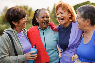 Fit elderly women having fun together at city park after sport workout - Healthy multiracial senior people and community concept © Sabrina