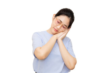 Fototapeta premium A young woman in a light blue shirt is gently cradling her face with her hands, conveying a sense of calm and relaxation.