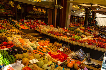Vibrant outdoor fruit market stall overflowing with a diverse colorful variety of fresh fruits