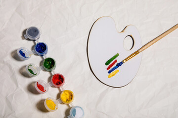 paint for drawing on a light table with paint strokes and a brush