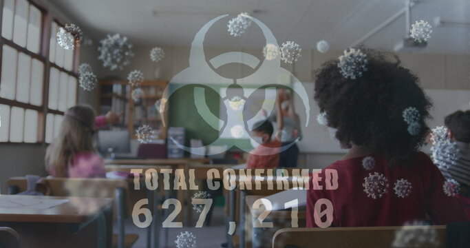 Biohazard symbol with increasing numbers against female teacher teaching in class at school - Powered by Adobe