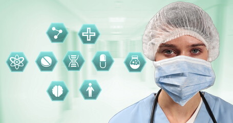 Multiple medical icons against portrait of female surgeon wearing face mask