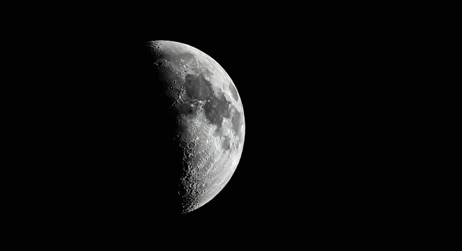 Close up picture of waxing crescent moon in blue sky