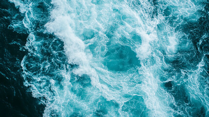 Aerial view of vibrant ocean waves crashing against each other, showcasing dynamic water movement