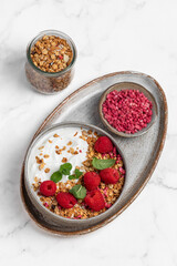 yogurt with granola and raspberries, breakfast