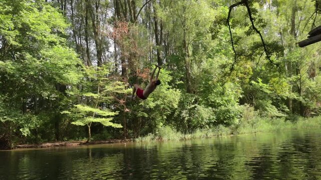 Rope swing river jump doing a flip, slow motion