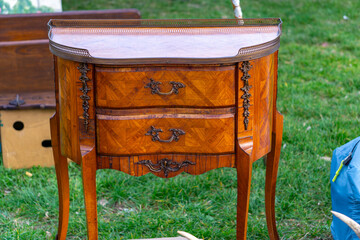 Stylish, antique chest of drawers with marble top. Wooden chest of drawers with richly decorated...